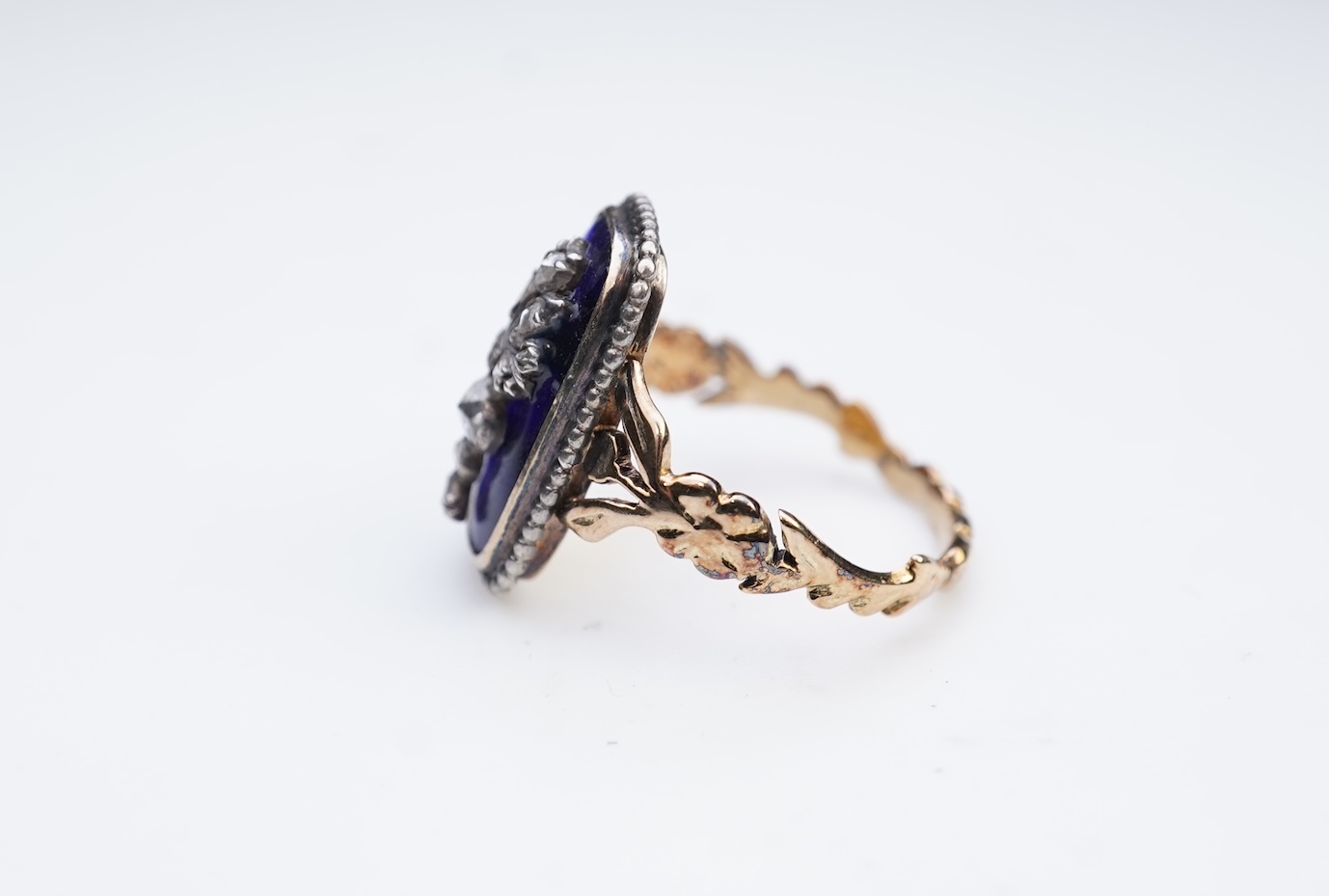 A diamond and blue glass ring